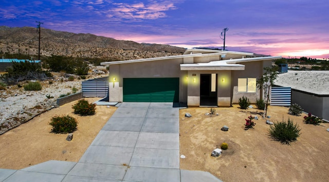 modern home featuring a garage and a mountain view