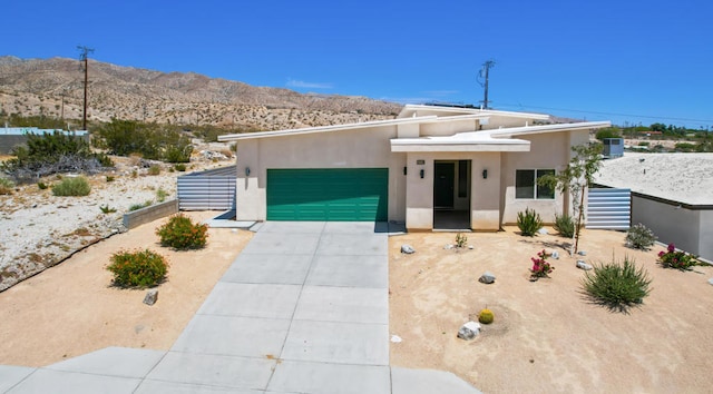 view of front of property with a mountain view and a garage