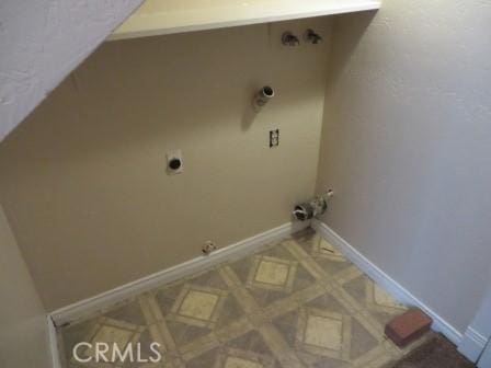 clothes washing area featuring electric dryer hookup and hookup for a gas dryer