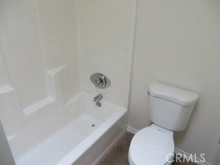 bathroom with shower / bathing tub combination and toilet