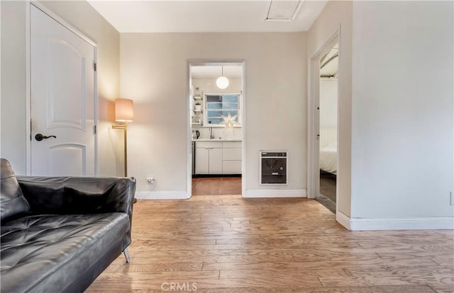 interior space featuring wood-type flooring and heating unit