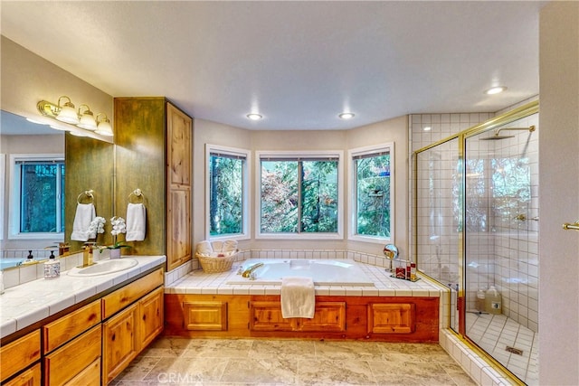 bathroom featuring vanity and shower with separate bathtub