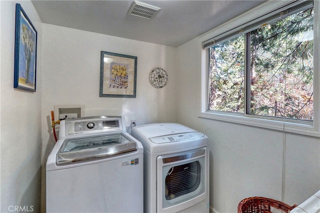 clothes washing area with washing machine and clothes dryer