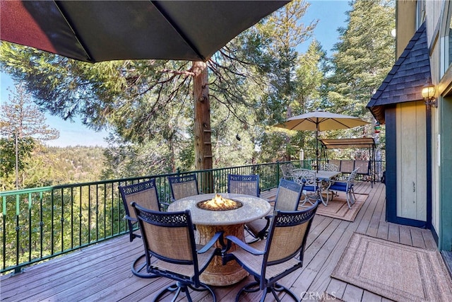 wooden deck with a fire pit