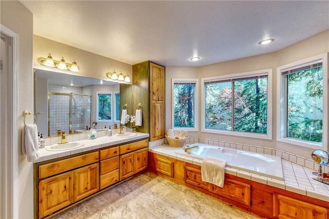 bathroom featuring a shower with door and vanity