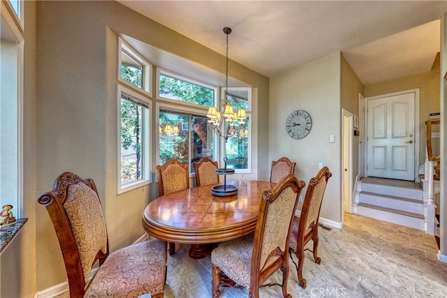 dining space with a notable chandelier