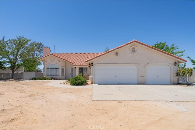 mediterranean / spanish home featuring a garage