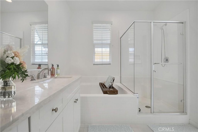 bathroom with vanity and separate shower and tub