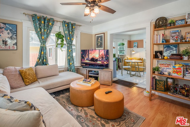 living room featuring ceiling fan and light hardwood / wood-style floors