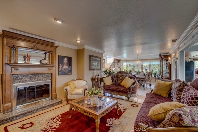 living room with an inviting chandelier, a textured ceiling, a premium fireplace, and crown molding