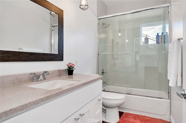 full bathroom with vanity, toilet, and shower / bath combination with glass door