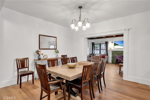 dining room with a notable chandelier and light wood-type flooring