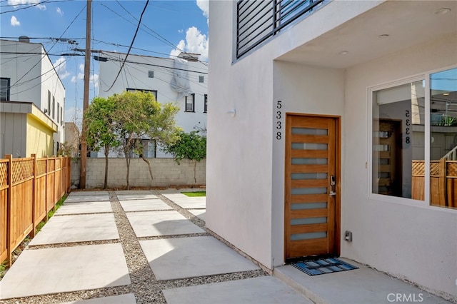 view of exterior entry with a patio area