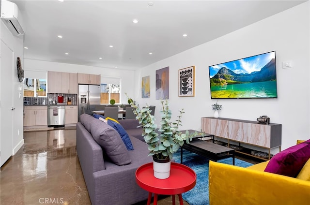 living room with concrete floors, sink, and a wall unit AC