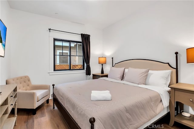 bedroom with dark hardwood / wood-style flooring