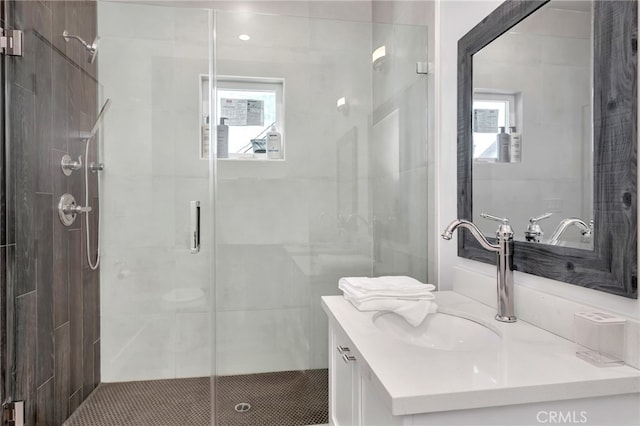 bathroom with vanity, a healthy amount of sunlight, and an enclosed shower