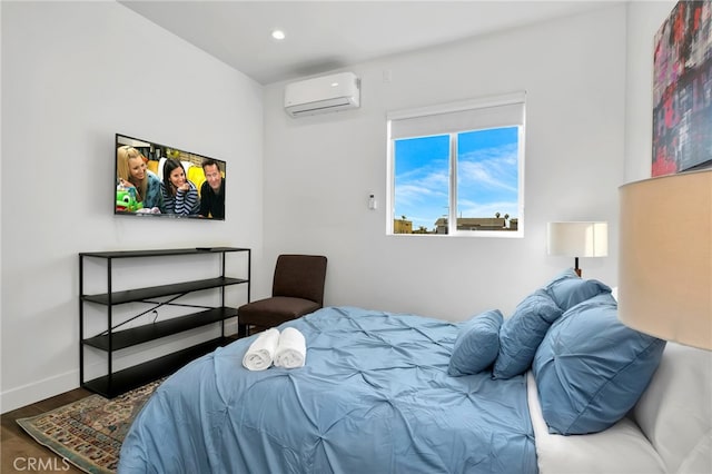 bedroom with hardwood / wood-style flooring and a wall mounted AC