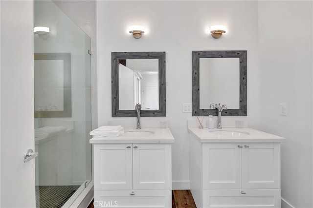 bathroom featuring vanity, walk in shower, and wood-type flooring