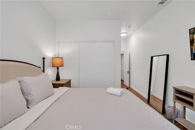 bedroom featuring a closet and wood-type flooring