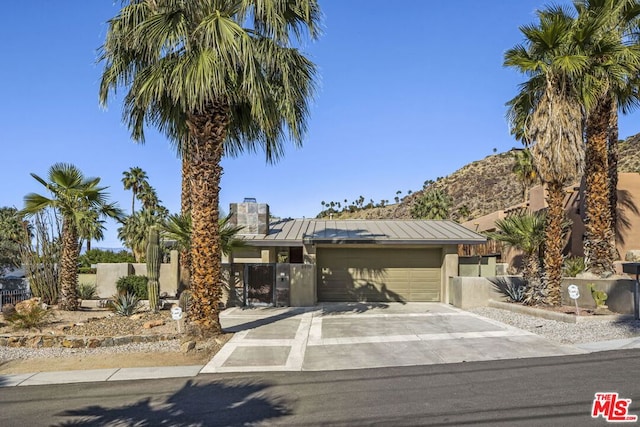 view of front facade with a mountain view and a garage