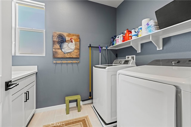 laundry area with separate washer and dryer, cabinets, and light tile patterned floors