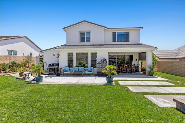 back of property with a lawn, a patio, and an outdoor living space