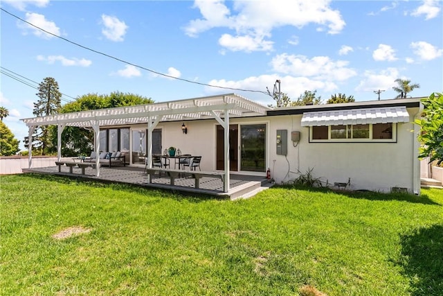 back of house with a yard and a pergola