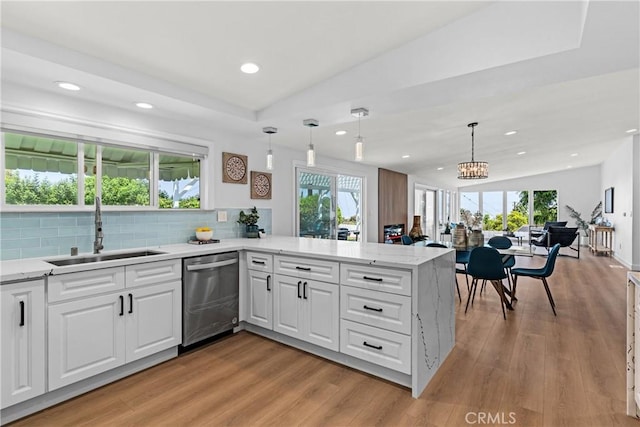 kitchen with sink, white cabinetry, kitchen peninsula, and dishwasher