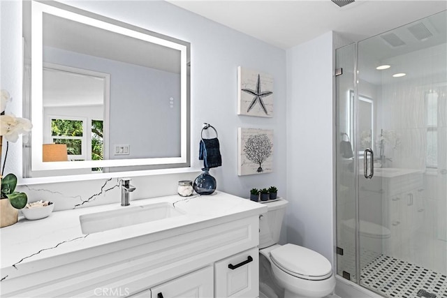 bathroom with vanity, toilet, and an enclosed shower