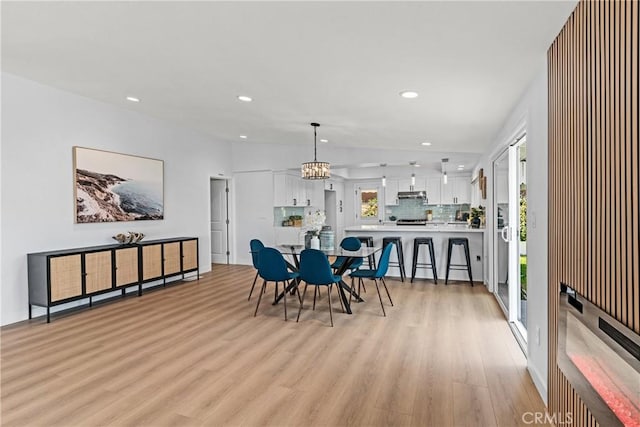 dining room featuring a notable chandelier and light hardwood / wood-style floors