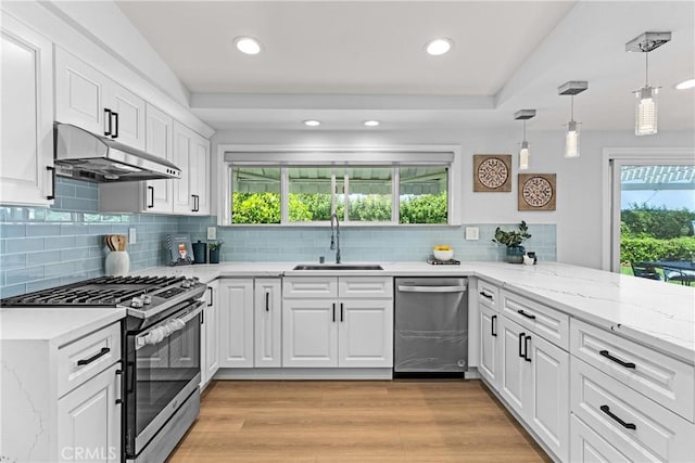 kitchen with sink, white cabinetry, pendant lighting, and appliances with stainless steel finishes