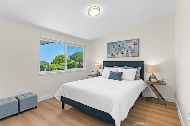 bedroom featuring wood-type flooring and lofted ceiling