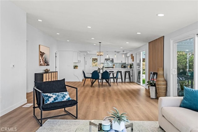 living room featuring light hardwood / wood-style flooring and vaulted ceiling