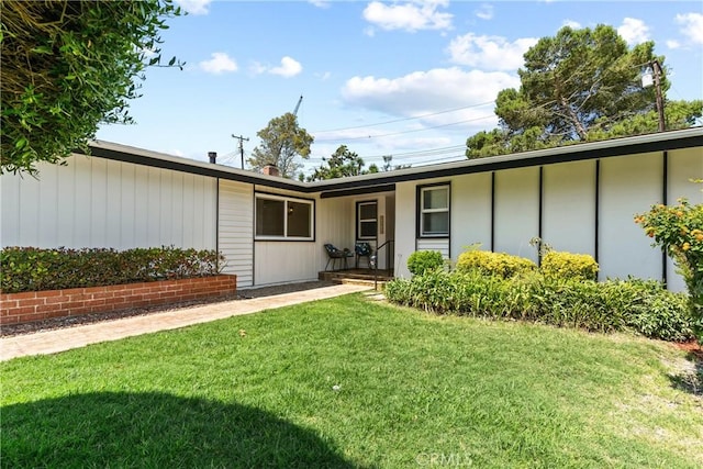 exterior space with covered porch and a lawn