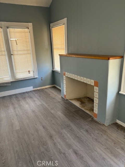 unfurnished living room featuring hardwood / wood-style floors and a fireplace