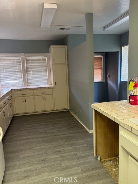 kitchen with cream cabinets, tile countertops, and light wood-type flooring