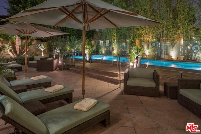 view of patio / terrace featuring an outdoor hangout area and a fenced in pool