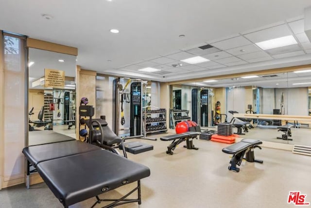 gym featuring a paneled ceiling