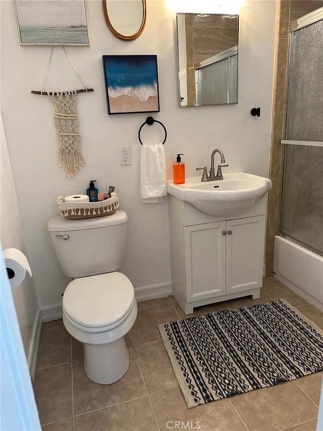 full bathroom with toilet, tile patterned flooring, enclosed tub / shower combo, and vanity