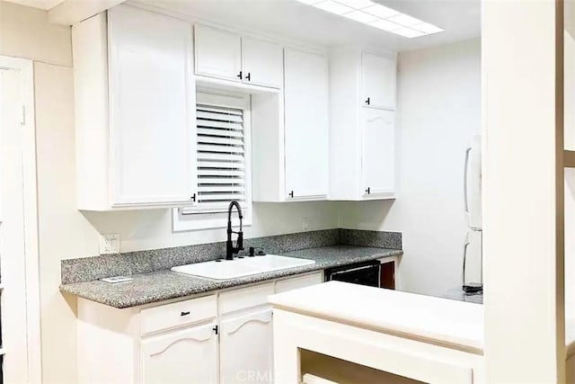 kitchen featuring white cabinetry, black dishwasher, white refrigerator, and sink