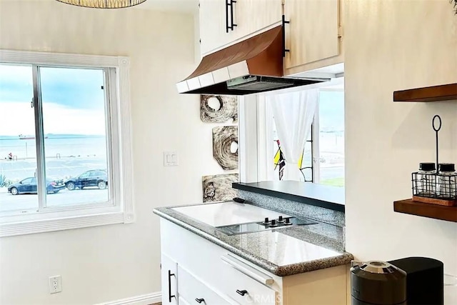 kitchen with light stone countertops and a wealth of natural light