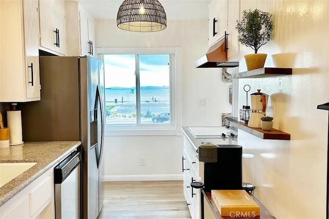 kitchen with stainless steel appliances, light hardwood / wood-style floors, and white cabinets