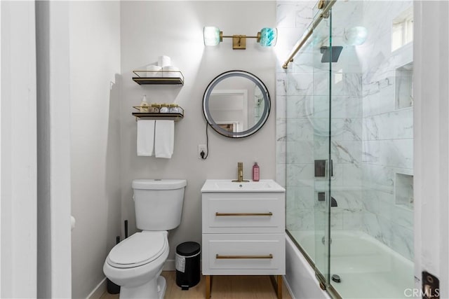 full bathroom with vanity, hardwood / wood-style flooring, shower / bath combination with glass door, and toilet