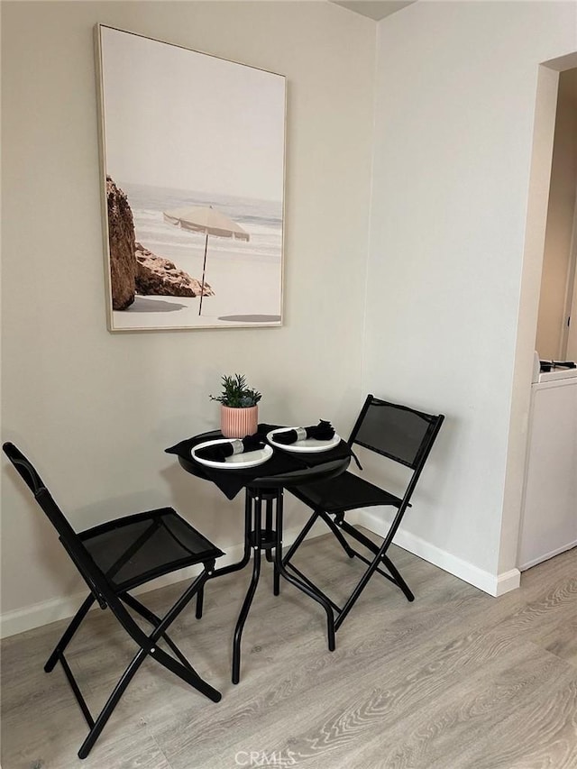 dining room with washer / clothes dryer and light hardwood / wood-style floors