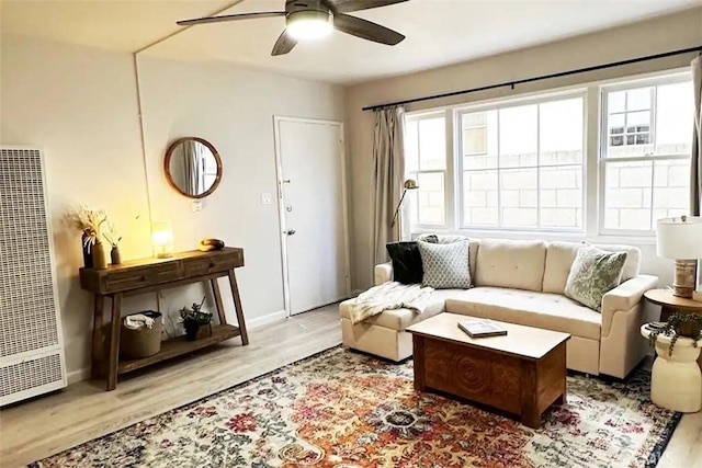 living room featuring ceiling fan and light hardwood / wood-style flooring