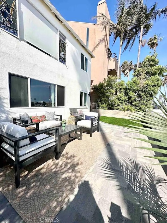 view of home's community with outdoor lounge area and a patio