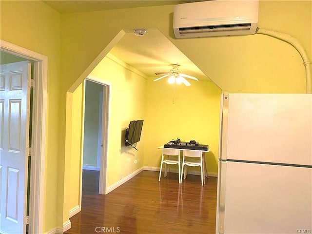 interior space featuring an AC wall unit, ceiling fan, and dark hardwood / wood-style flooring