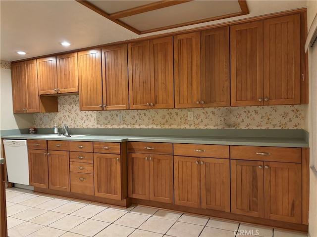 kitchen with light tile patterned floors, sink, and white dishwasher