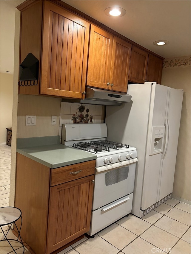 kitchen with light tile patterned floors and white appliances