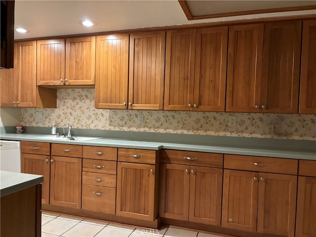 kitchen with light tile patterned floors, sink, and white dishwasher